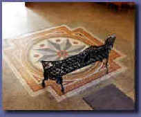 View of cast iron bench and floor in front lobby,